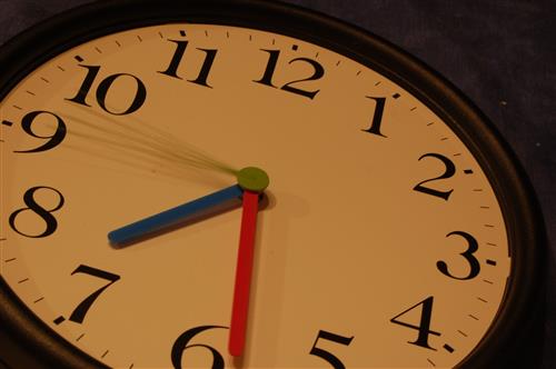 Clock with blue and red hands reading 7:30 Clock with blue and red hands reading 7:30