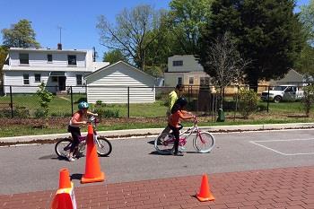 Kids on bikes and orange cones