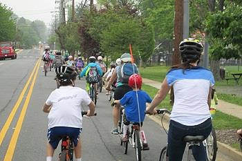 Mass of people riding bikes down the street 